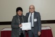 Dr. Nagib Callaos, General Chair, giving Dr. Odette Bourjaili Radi the best paper award certificate of the session "Training & Education: Research, Theories, Practice, and Innovations". The title of the awarded paper is "Secondary Schools Students’ Language Literacy Skills Aided by the Use of Computer Tools."